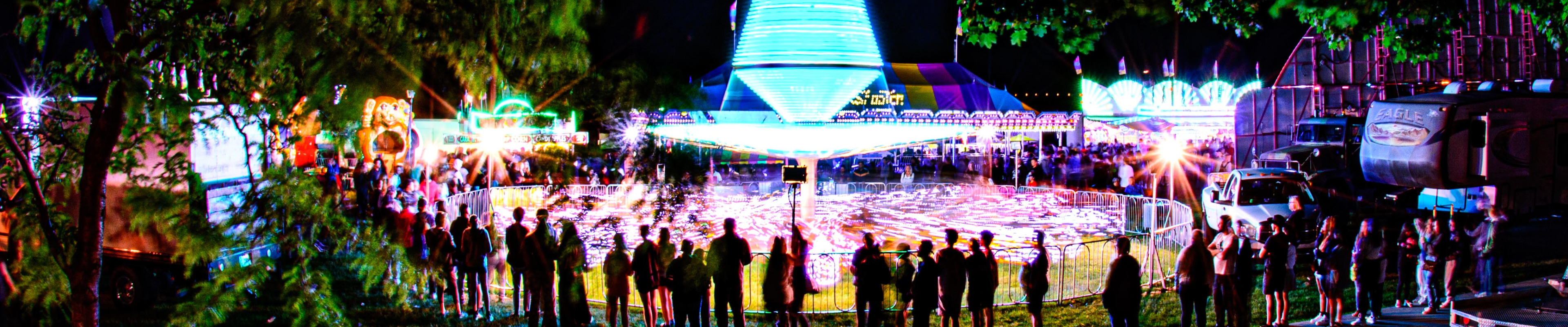 image of carnival rides at night